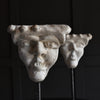 A Pair of 19th Century Grotesque Plaster Heads on Stands.